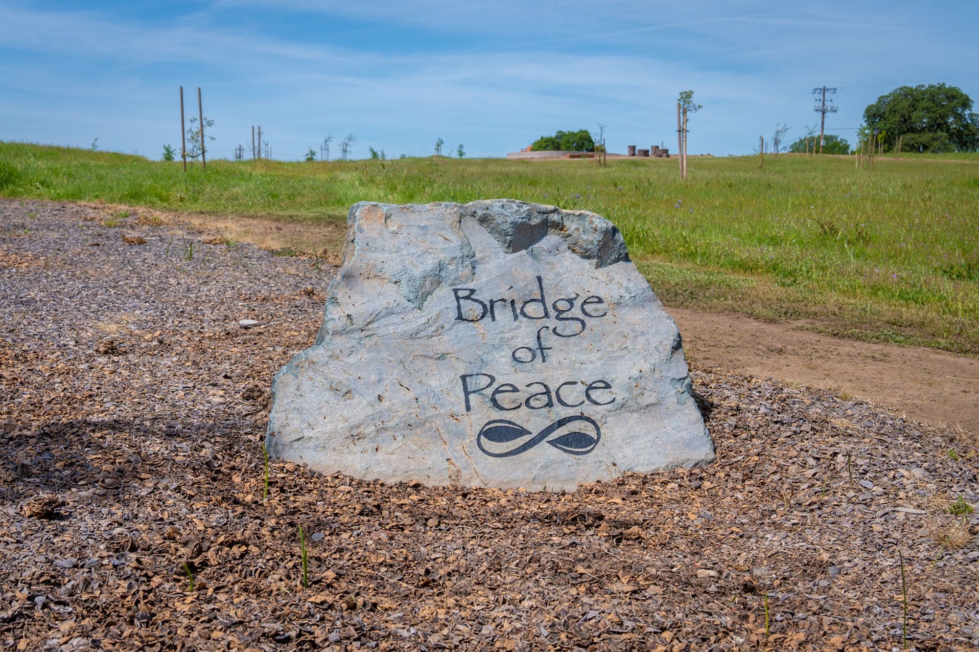 Engraved Bridge of Peace boulder marking the cremation garden entrance