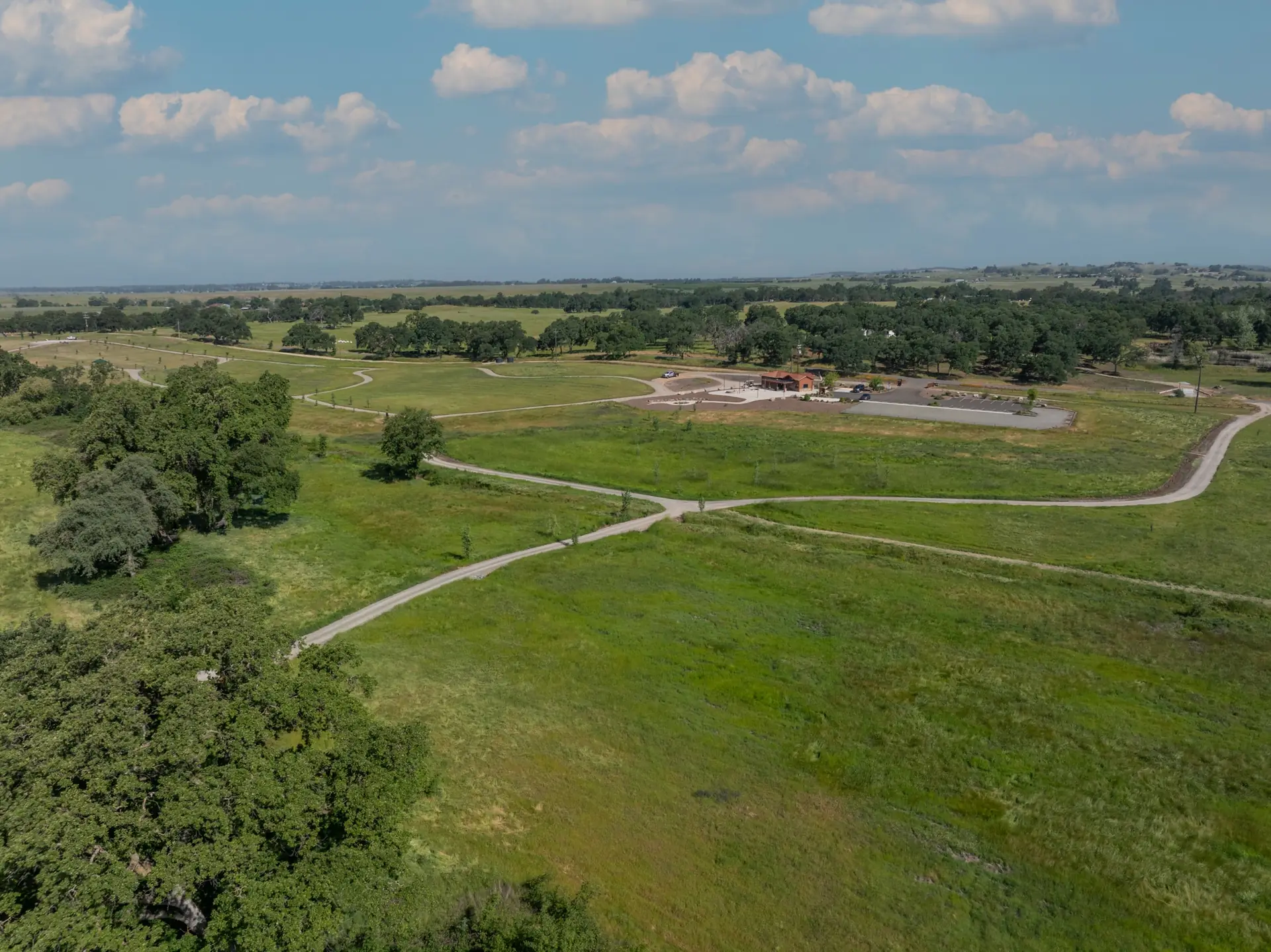 Aerial view of Morgan Oaks Eternal Preserve: winding gravel trails through green meadows and native oak woodland in Lincoln, California
