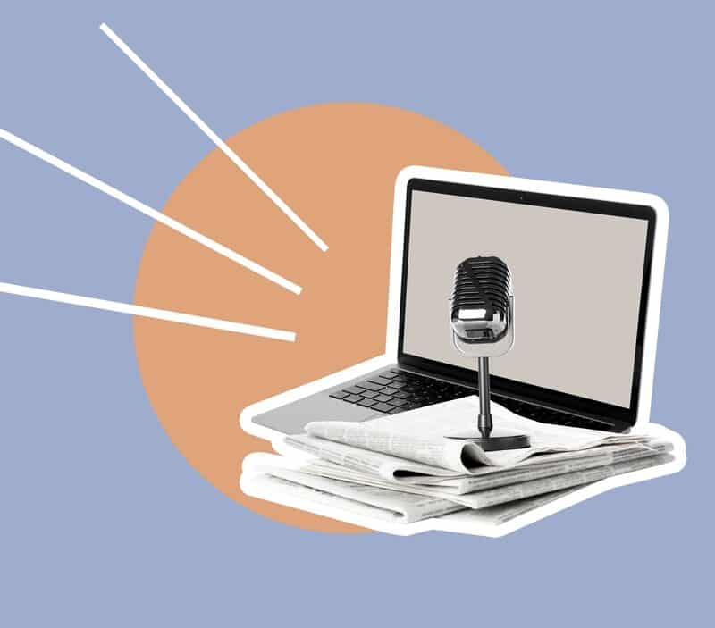 Laptop with microphone on newspapers, digital communication
