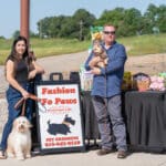 Couple with dogs at 'Fashion Fo Paws' pet event