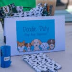 Cartoon dog illustration on poop bag dispenser sign