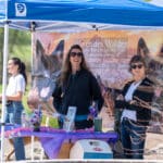 People at German Shepherd dog breed promotional booth