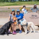People and dogs by Morgan Oaks Eternal Preserve sign