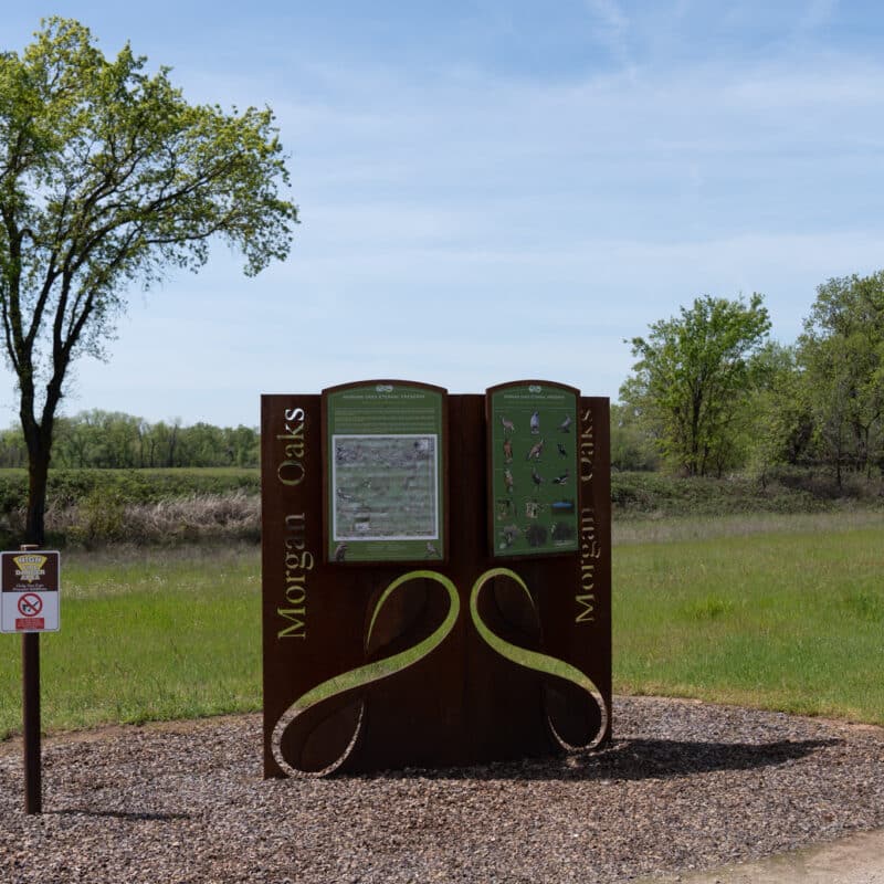 Morgan Oaks informational signboard in a serene park