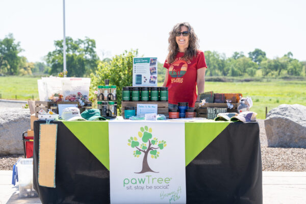 Woman smiling at outdoor pet product booth