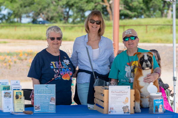 _A745190 Volunteers at pet adoption booth with dog