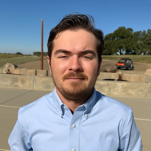Man in blue shirt outdoors, sunny day